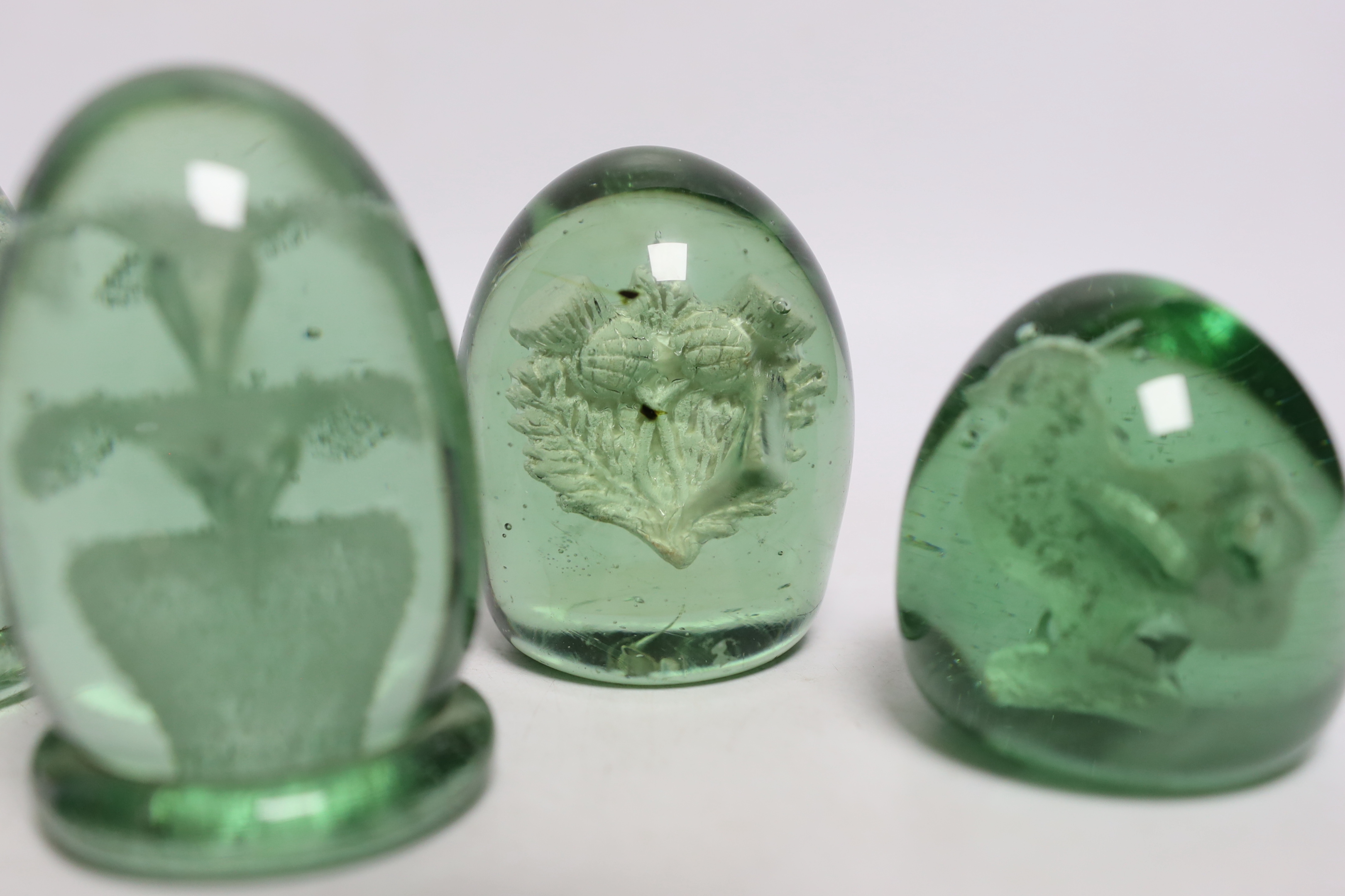 Five green glass dumps, including two with inset sulphides, tallest 9cm